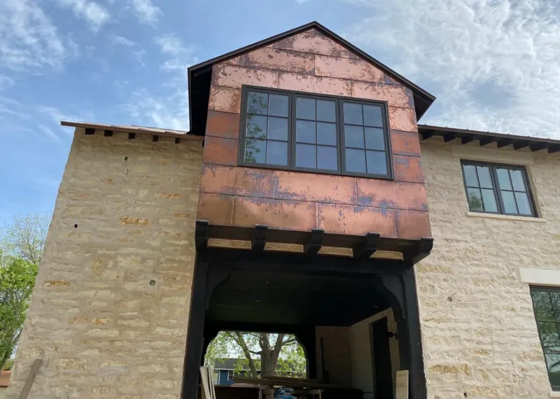 Copper metal panel facade on a stone building for Roof Repair in Abington